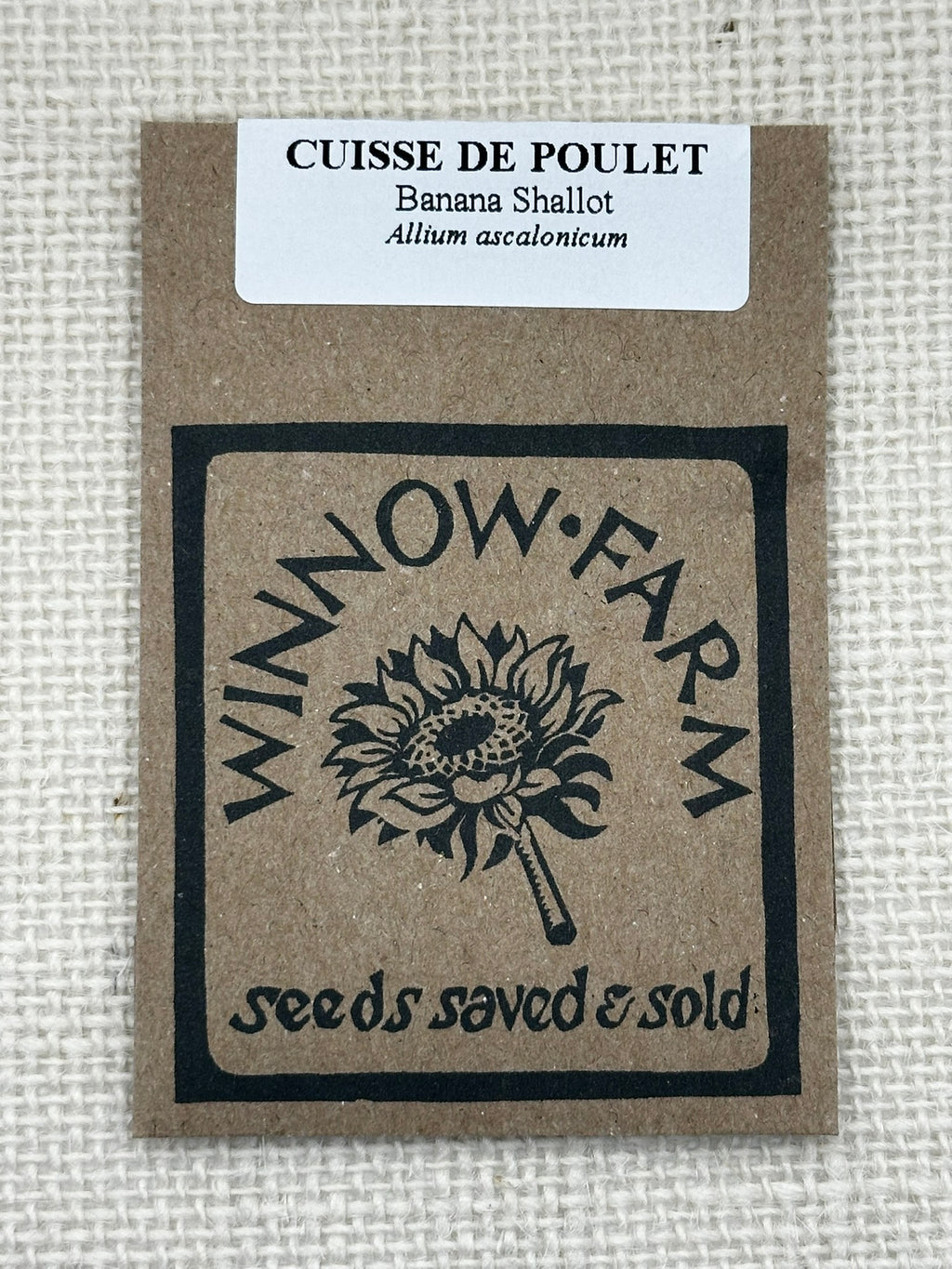 Seed packet from Winnow Farm with branding and product details on a textured background