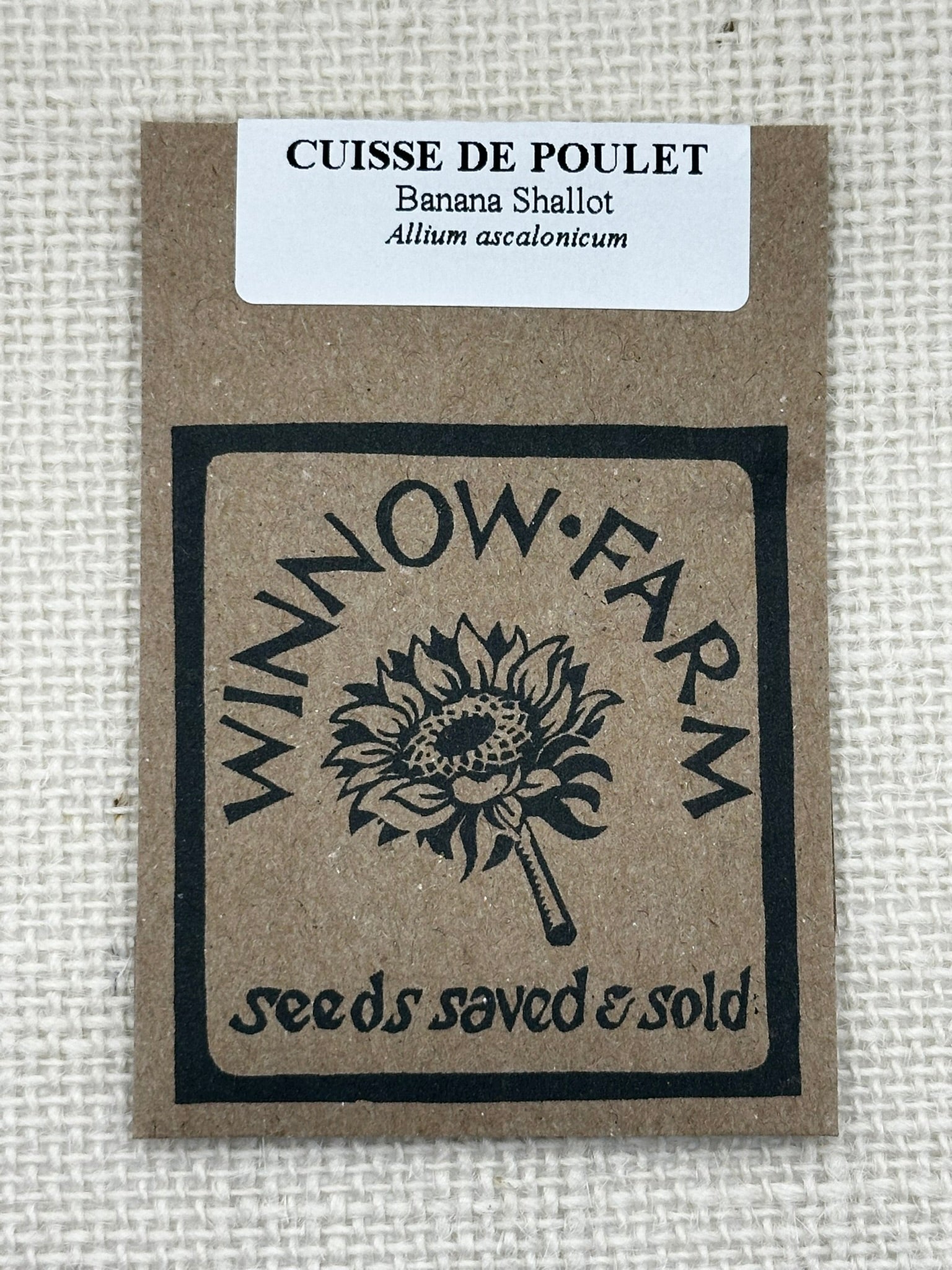 Seed packet from Winnow Farm with branding and product details on a textured background