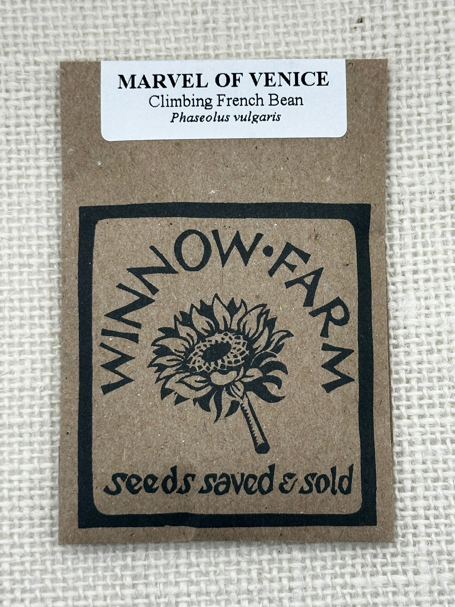 Seed packet from Winnow Farm with Marvel of Venice climbing French bean label on a textured beige background.