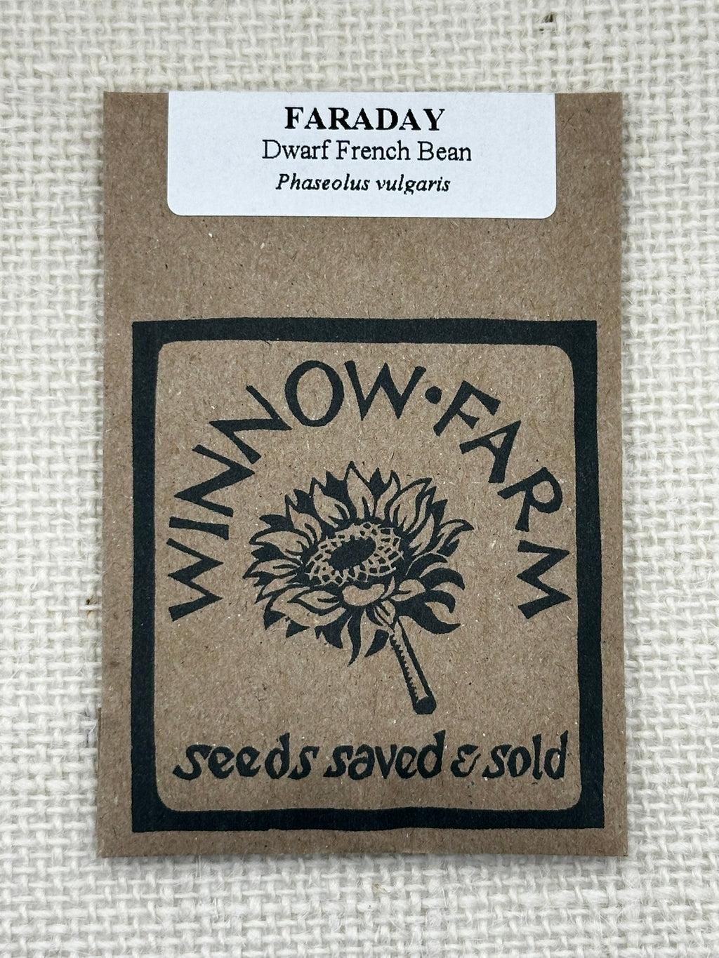 Seed packet for Faraday Dwarf French Bean with Winnow Farm logo on a textured beige background