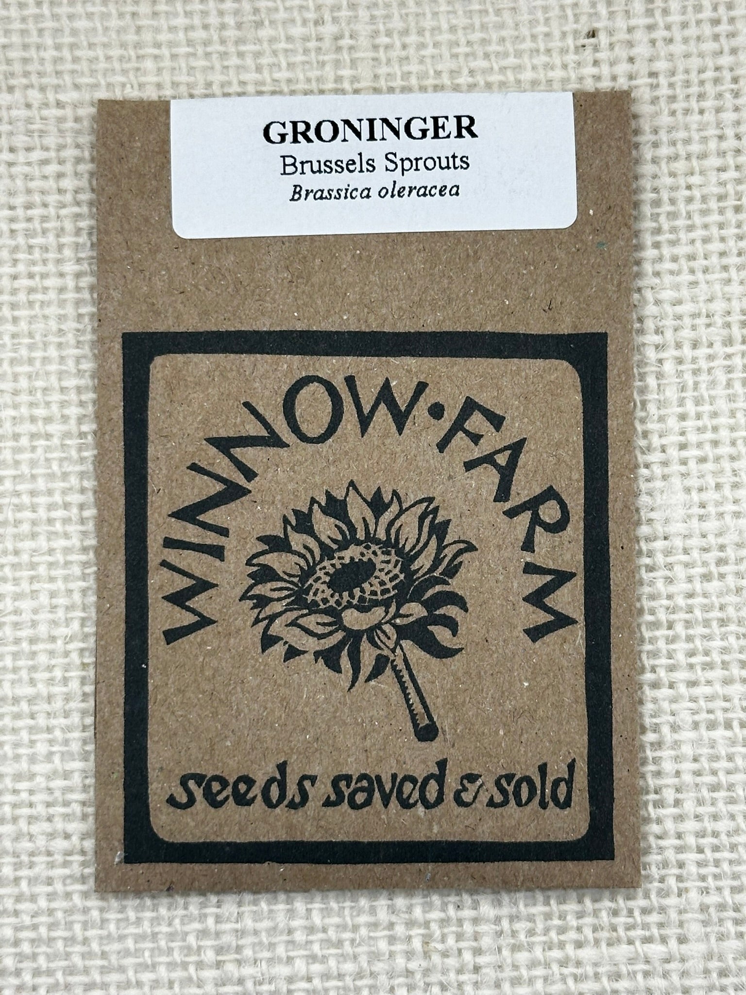 Seed packet for Groninger Brussels Sprouts with Winnow Farm branding on a textured beige background.