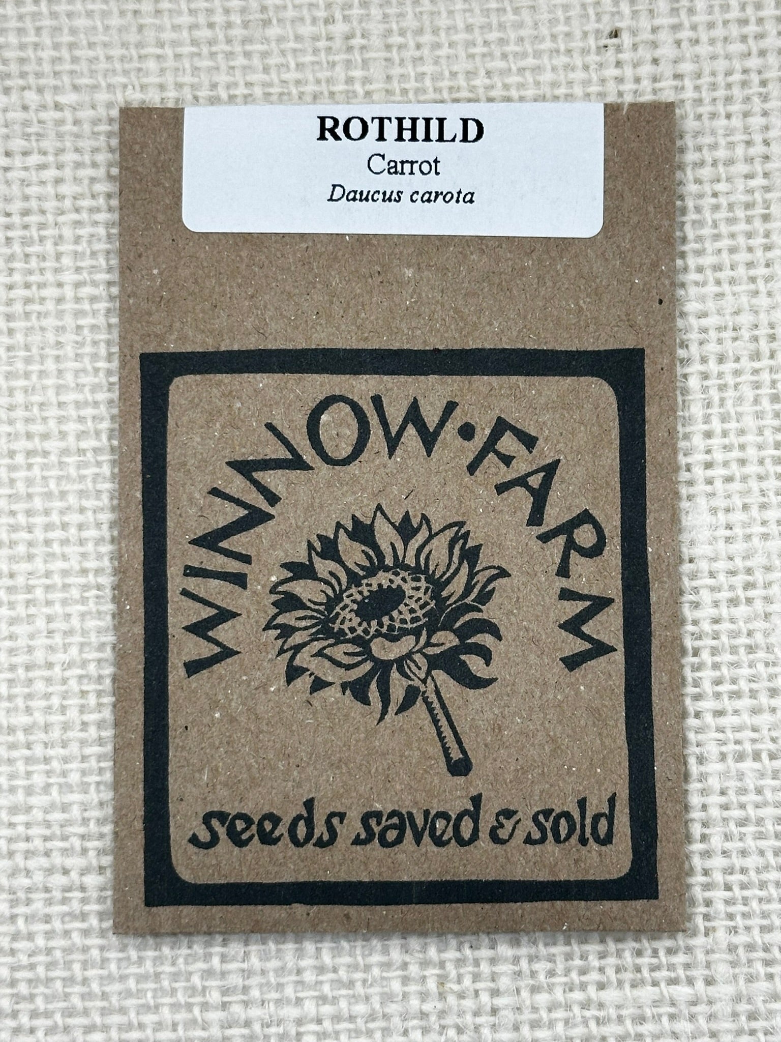 Seed packet with 'Winnow Farm' logo and text on a textured background