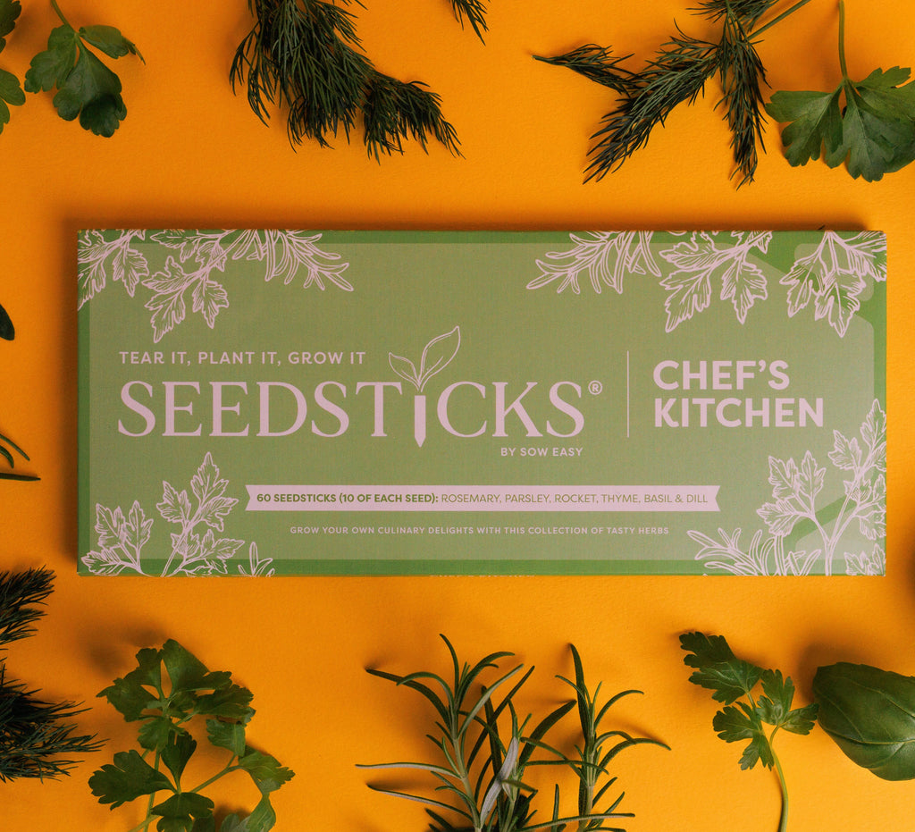 Seedsticks by Chef's Kitchen packaging on a yellow background with herbs