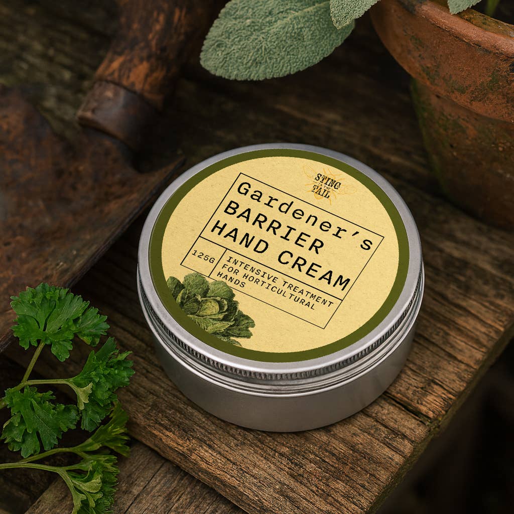 Gardener's Barrier Hand Cream jar on a wooden surface with plants around